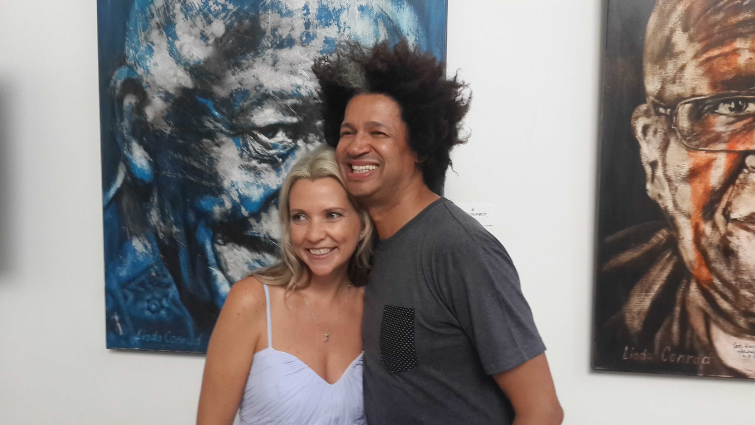 Stephanie with Mark Lottering with a painting behind them